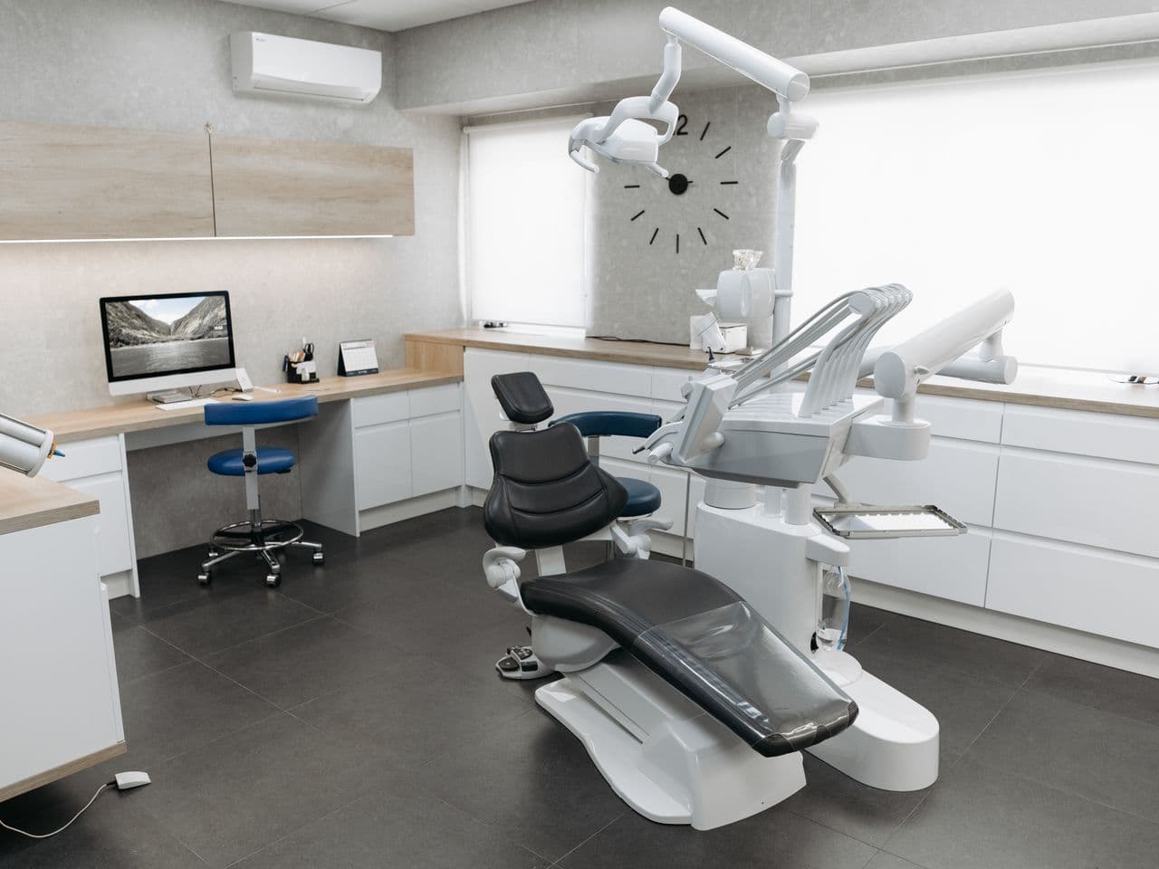 Spacious contemporary dental treatment room flooded with light