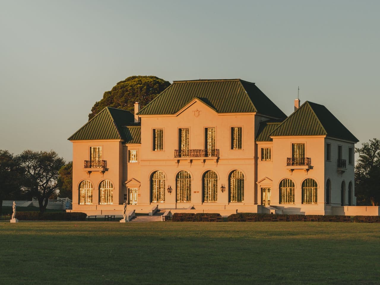 Stately manor exterior bathed in the last light of sunset